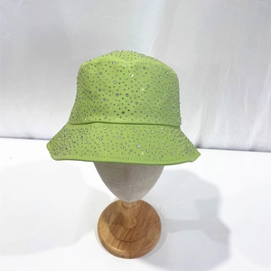 Detail of lime green bucket hat featuring all-over sparkling silver rhinestones on cotton