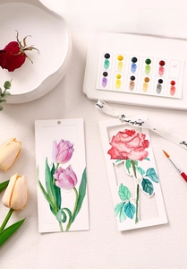 Detail of hollow watercolor bookmarks with floral motifs and compact paint palette