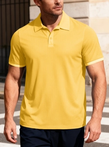 Detail of yellow cotton piqué polo shirt featuring breathable mesh fabric and ribbed cuffs