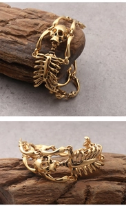 Macro detail of gothic gold skeleton bracelet made of durable stainless steel on wood
