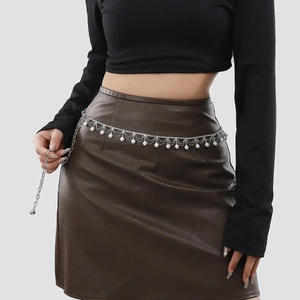 Detail of silver layered waist chain with pearls and rhinestones on a leather skirt