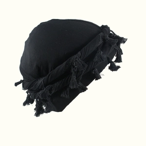 Men's black turban headwear with satin lining and decorative tassels on white background
