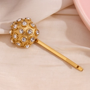 Detailed close-up of 18K gold plated hair clip with spherical head and clear rhinestones
