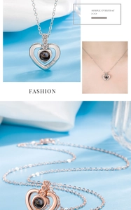 Macro detail of silver and rose gold heart projection necklaces with Love engraving