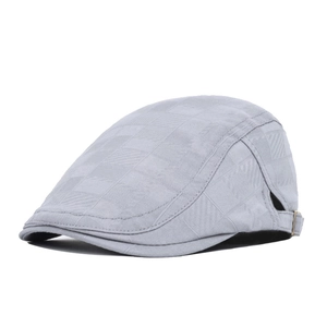 Detail of light gray newsboy cap featuring checkered texture and adjustable metal buckle