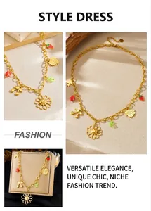 Detailed close-up of golden chain necklace with floral, cherry and heart charms