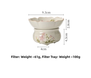 Detailed view of hand-painted ceramic tea strainer with cherry blossom and base