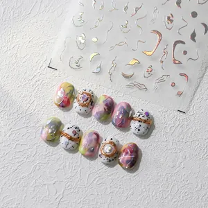 Detail of silver 3D nail art stickers with metallic line borders and pearl accents