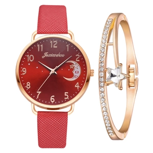Detail view of red starry sky dial watch and matching gold rhinestone moon bracelet set