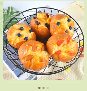 Detailed macro view of 5 assorted artificial muffins with berries in a black metal basket