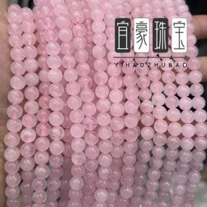 Close-up of natural rose quartz round beads strands for DIY jewelry making and crafts
