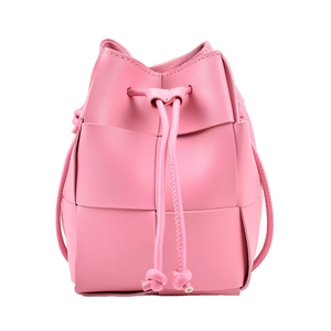 Pink woven leather mini bucket bag with drawstring closure on white background