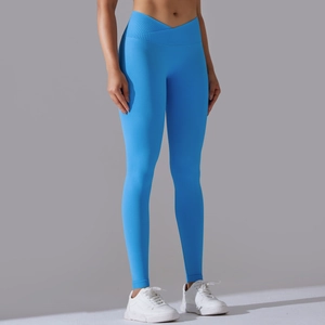 Detail of high-waist crisscross V-shaped waistband on bright blue seamless yoga pants