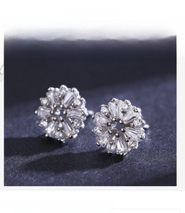 Macro detail of S925 silver flower stud earrings with sparkling cubic zirconia inlay