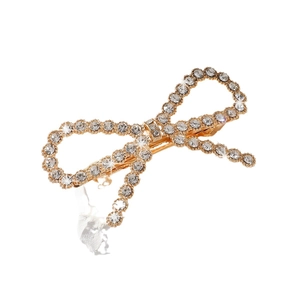Elegant gold bow hair clip with sparkling rhinestones and pearls on white background