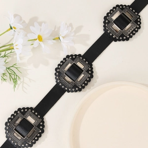 Vintage PU leather belt with decorative square metal buckles on a minimalist background