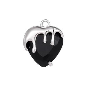 Macro detail of heart pendant with silver liquid metal over faceted black crystal