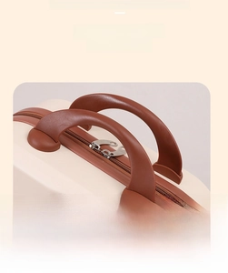 Detail of soft rubber handle and smooth metal zippers on macaron 14-inch mini suitcase