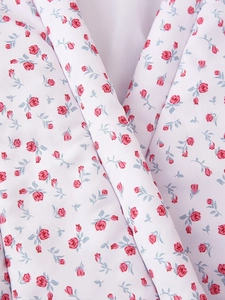 Close-up of white fabric texture with small pink roses and blue leaves floral patterns