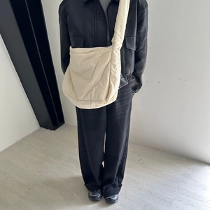 White sponge tote bag with soft texture and large capacity worn by a model