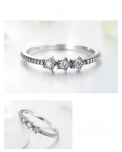 Macro detail of S925 silver star ring with triple zircon inlay and beaded texture band