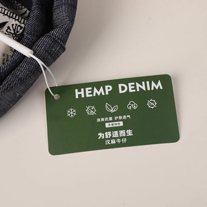 Detail of hemp denim beret showing breathable fabric texture and quality product tags