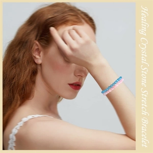 Healing natural crystal stone stretch bracelets in blue and pink worn on a model's wrist