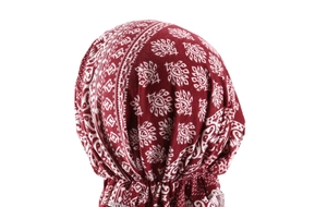 Detail view of burgundy pre-tied turban hat showing ethnic print and elastic pleats