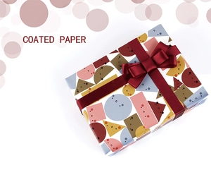 Detail of high-quality coated paper gift wrap with geometric patterns and burgundy ribbon