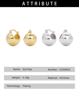 Macro detail of S925 sterling silver ball earrings showing gold plating and metal texture