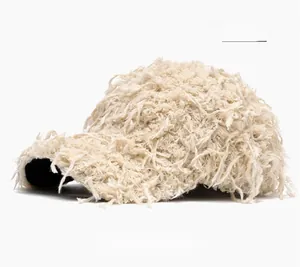 Detail view of the fuzzy beige faux fur baseball cap with fluffy plush texture and soft lining