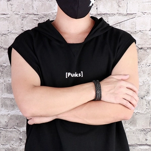 Close-up of a men's punk braided black leather bracelet with stainless steel chain link