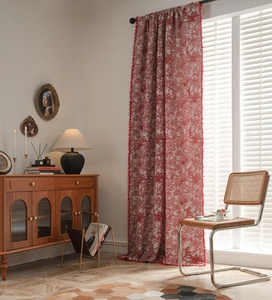 Detail of red and white vintage pattern curtain with decorative pom-pom fringe trim