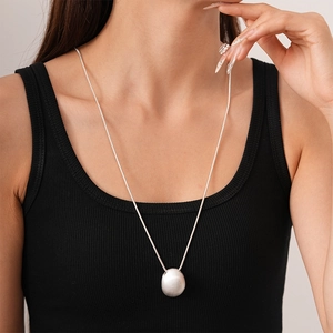 Minimalist silver oval pebble pendant necklace on a sleek snake chain for women