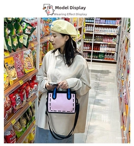 Close-up of pink 2D cartoon tote bag with blue handles and adjustable black strap
