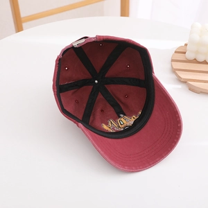 Detail view of cotton baseball cap interior showing black seam tape and adjustable buckle