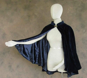 Detail of dark blue velvet cape showing the stand collar and golden metal buckle