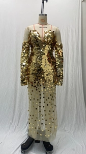 Detail of gold sequins on mesh dress with off-shoulder neckline and sheer skirt
