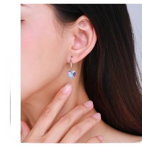 Close-up of s925 sterling silver heart-shaped crystal earrings in gradient blue-purple