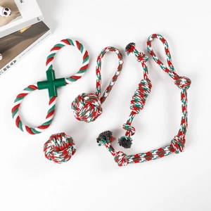 Detail view of a 4-piece Christmas pet rope toy set in red, green, and white cotton
