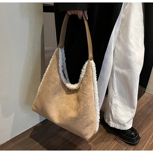Detail of khaki tote bag featuring soft white plush trim and faux suede material texture