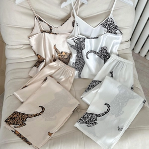 Elegant satin pajama set featuring chic leopard print camisole and matching trousers