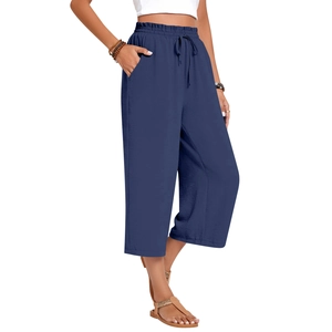 Detail of high waisted linen trousers showing elastic drawstring waist and side pockets