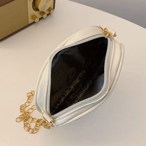 White round heart-stitched girl's crossbody bag with gold chain and open zipper view