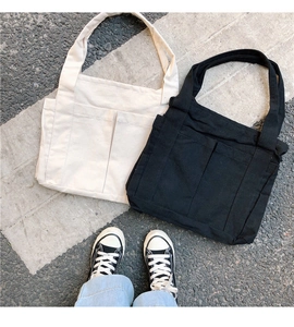 Détails de grands sacs fourre-tout en toile noir et beige avec poches avant pratiques