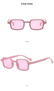 Detail view of pink rectangular sunglasses with gold metal accents and sleek temples