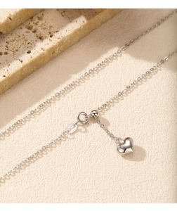 Macro shot of S925 sterling silver heart pendant and adjustable slider clasp details