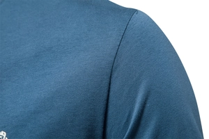 Macro shot of durable shoulder stitching and cotton fabric texture on blue V-neck T-shirt