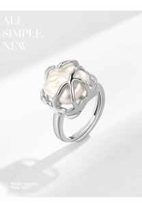 Macro detail of French style vine silver ring featuring a baroque pearl and open band