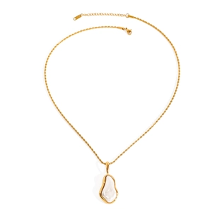Detail of gold stainless steel necklace with an irregular white pendant on white backdrop